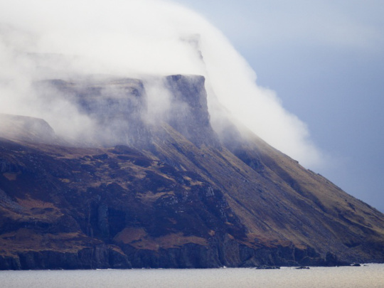 impressive cliffs with mists furling over teh top