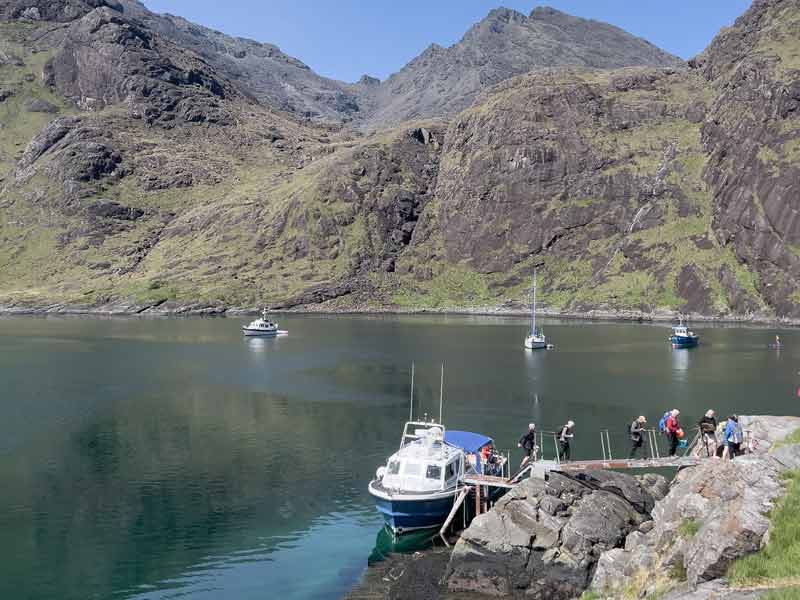 boat at pier by mountain loch