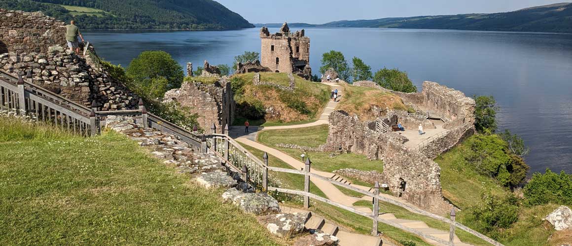 ruins of a large castle on the shores of loch ness
